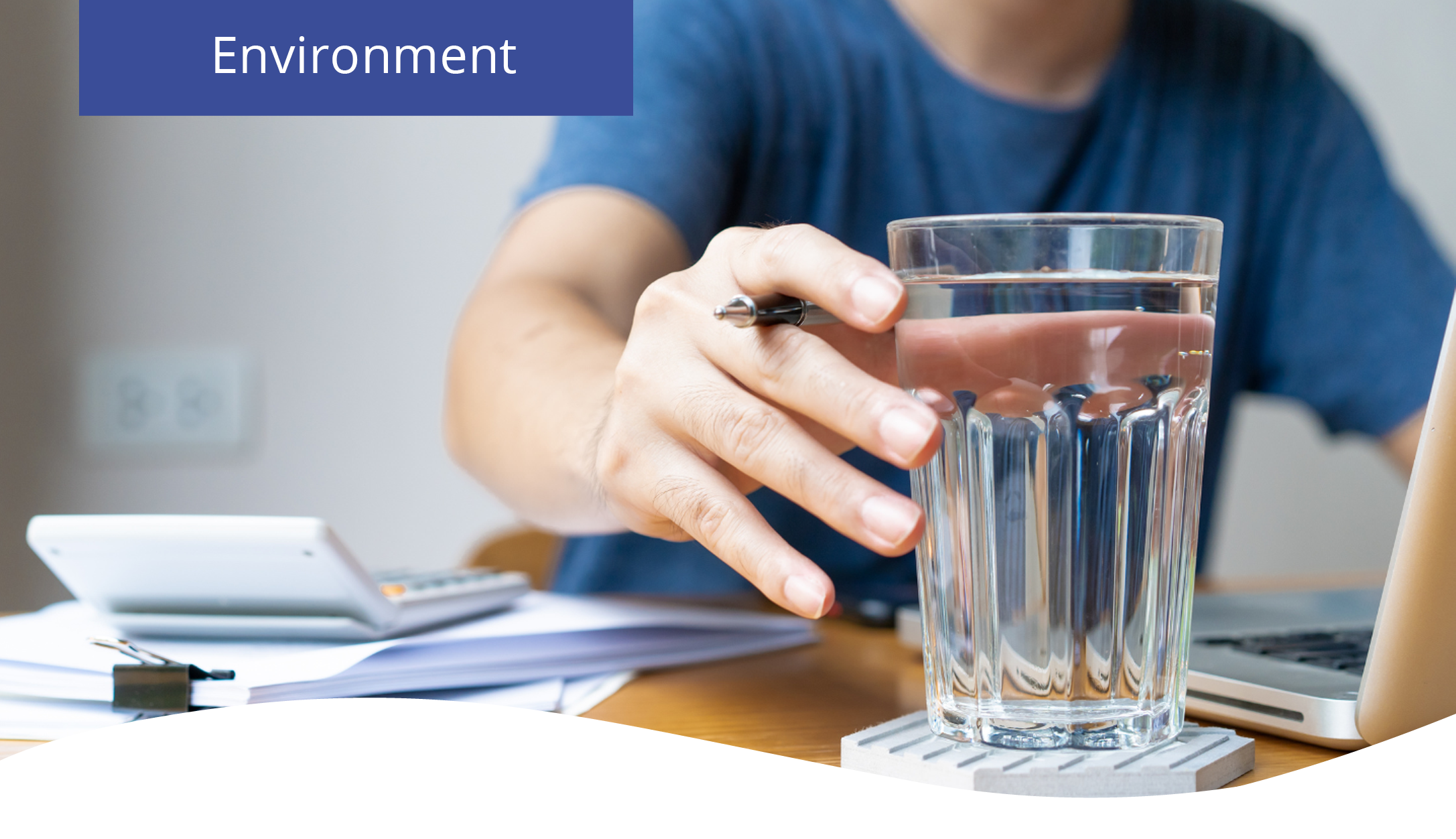 A cup of fresh water from a water dispenser placed on an office desk